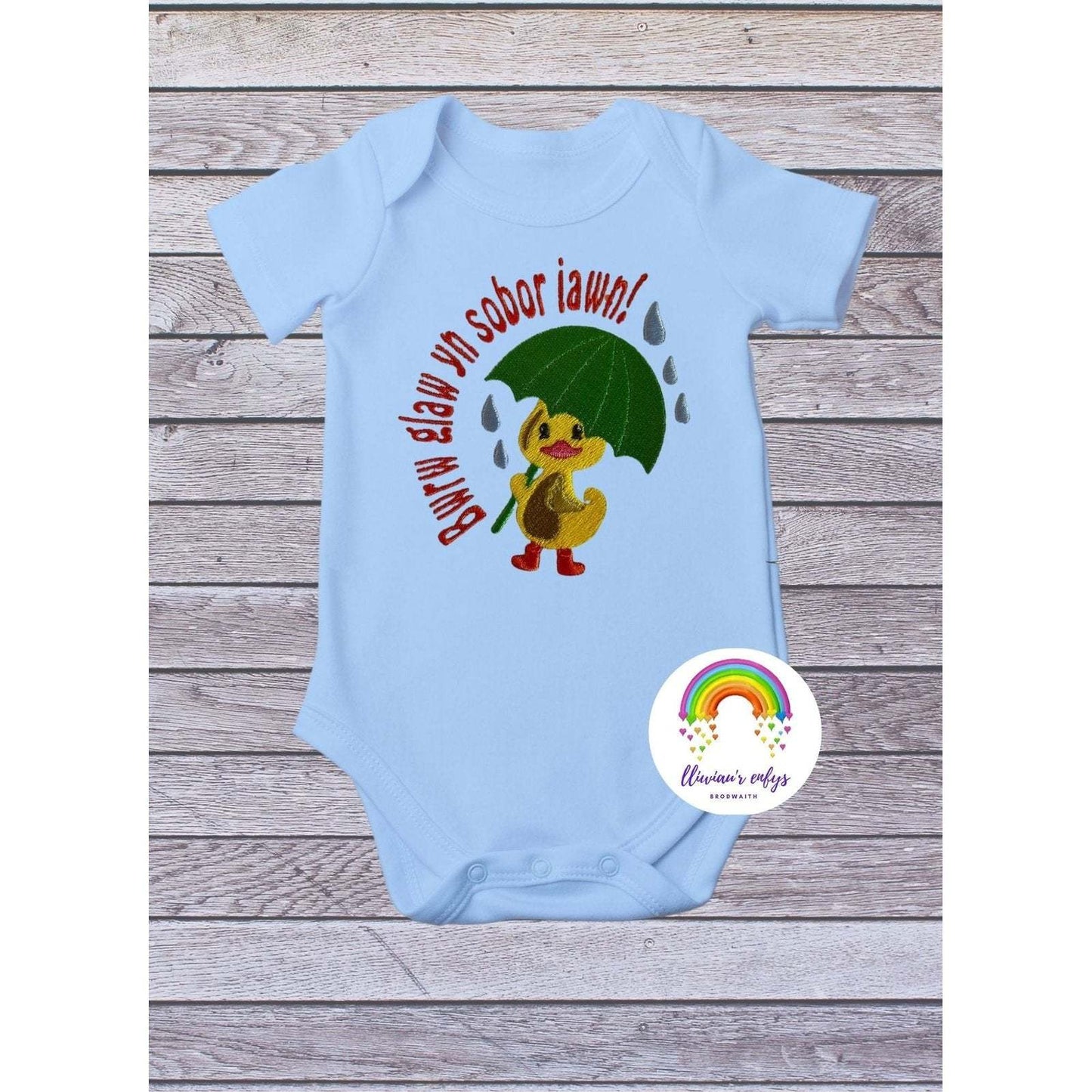 BRO-003 Newborn embroidered babygrow with Welsh words "Bwrw glaw yn sobor iawn"