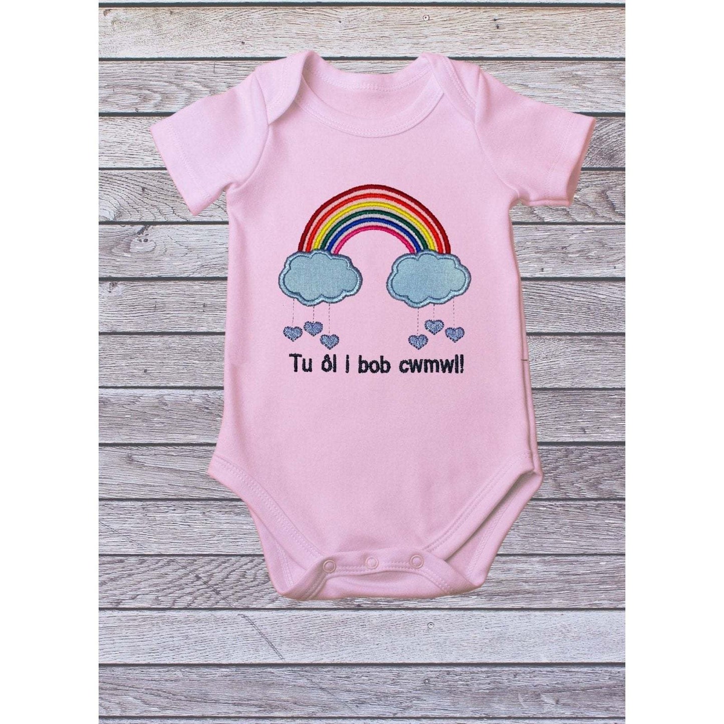 BRO-009 Embroidered rainbow babygrow with Welsh text "Tu ôl i bob cwmwl"